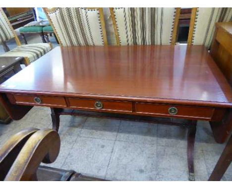 A mahogany drop end sofa coffee table fitted with three drawers