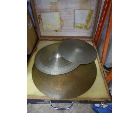 A wooden box containing three cymbals 