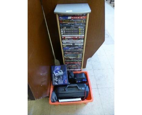 A dvd tower containing a quantity of dvds, together with a box of cameras, JVC video camera with film, digital camera etc 