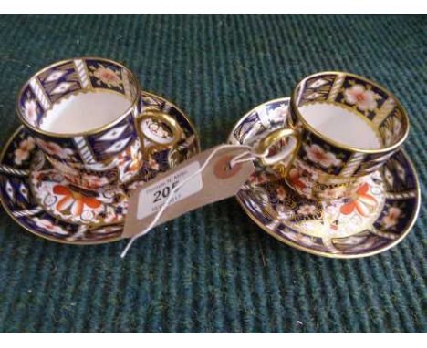 Two Royal Crown Derby gilded cups and saucers