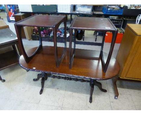 A contemporary oval mahogany coffee table together with pair of lamp tables 