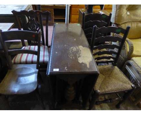 An oak drop leaf table, pair of ladder back chairs, kitchen chair and dining chair 