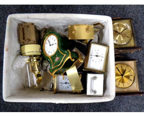 A basket of contemporary mantel clocks and a further metal mantel clock