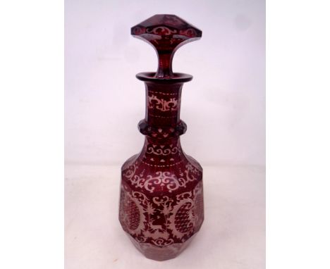 An antique Bohemian ruby glass decanter with stopper, height 32.5 cm.