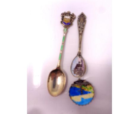 Two silver and enamel spoons together with a brooch.