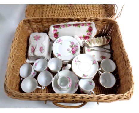 A wicker picnic basket containing a Czechoslovakian pink rose patterned tea service together with further Royal Albert Old Co