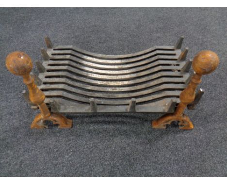 A 19th century cast iron fire grate together with a pair of fire dogs 