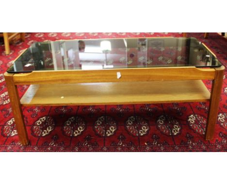 A Myer, teak and smoked glass coffee table, circa 1960s, rectangular form, the quarter segment legs united by a plain shelf, 