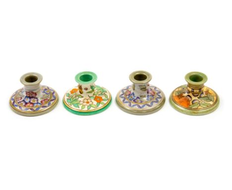 Charlotte Rhead for Bursley Ware, a pair of TL4 Arabesque candlesticks, together with a TL14 and TL5 candlestick, 10.5cm diam