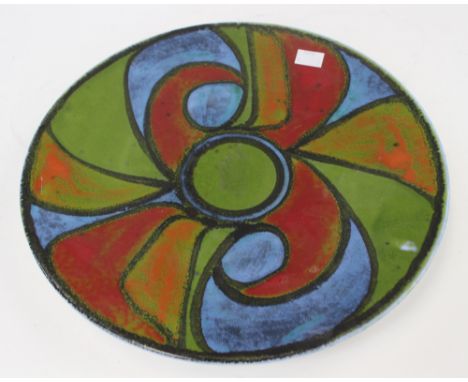 A Poole Pottery Delphis charger, by Gillian Taylor, 1971-72, decorated with an abstract wave and segment design in blue, gree
