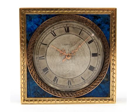Cartier, an Art Deco lapis lazuli and 9 carat gold bedside timepiece, the silvered engine turned dial signed Cartier, import 