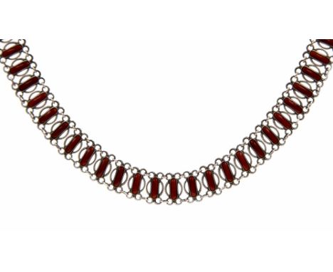 Arnie Nordlie, a Norwegian silver and enamelled collar, circa 1930, red enamel oblong and open ropework links, 41cm long