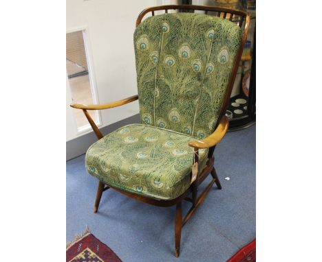 An Ercol Windsor high backed armchair, in stained beech, with spindle back