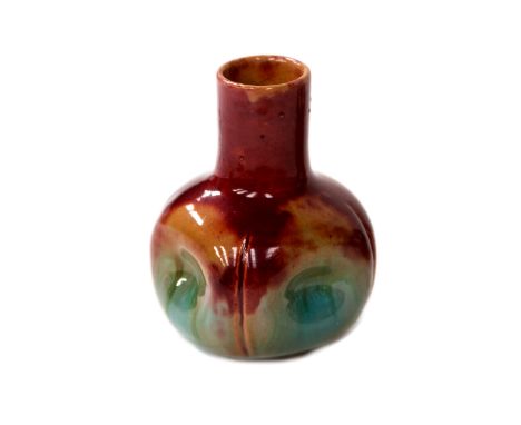 Christopher Dresser for Linthorpe (attributed), a miniature art pottery bottle vase, circa 1880, with dimpled sides, red/oran