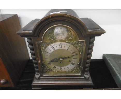 A LARGE OAK MANTLE CLOCK