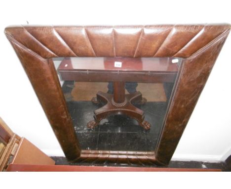 A LARGE LEATHER FRAMED MIRROR
