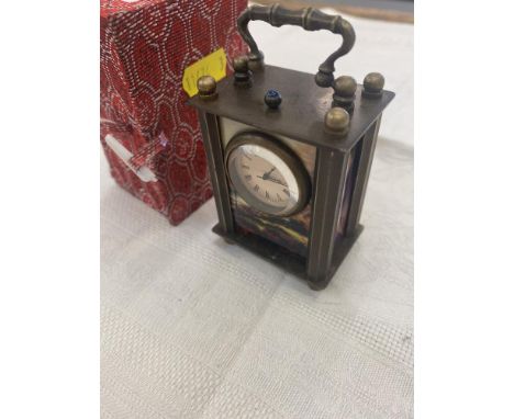 A miniature travelling clock with erotic panels