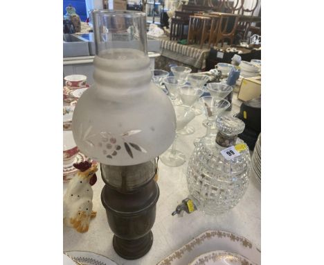 A cut glass decanter and a miniature oil lamp