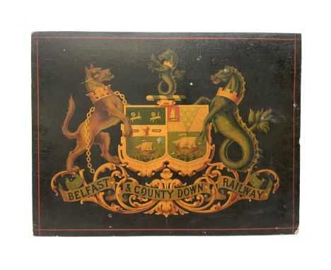 Late 19th/early 20th century Belfast &amp; County Down Railway railway sign, the wood panel decorated with transfer coat of a