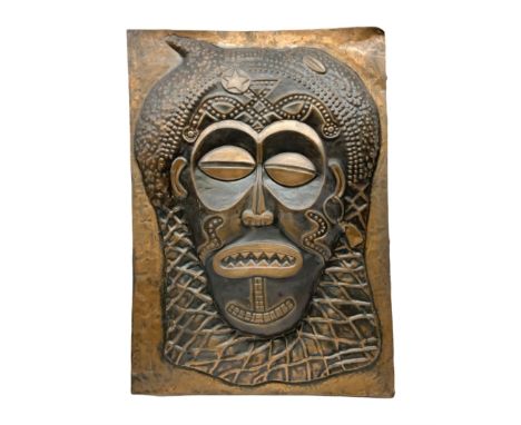 Copper panel embossed with a design of an African mask, H70cm, W50cm