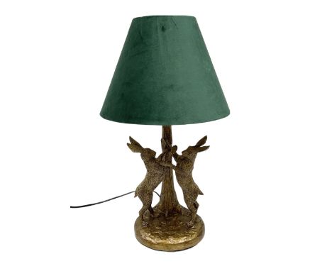 Composite table lamp, modelled as a pair of boxing hares, with a green velvet shade, H45cmDimensions: Height:&nbsp;48cm&nbsp;