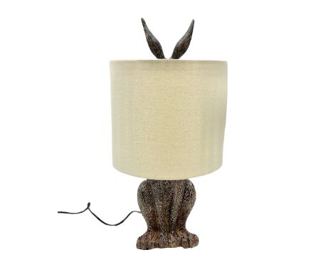 Composite table lamp, modelled as a hare with natural linen shadeDimensions: Height:&nbsp;50cm&nbsp; Length/Width:&nbsp;25cm&