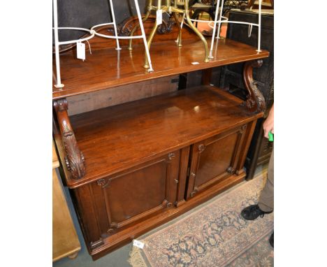 A Victorian mahogany buffet cupboard, the base with doors enclosing slides and a shelf, 133cm high, 137cm wide 