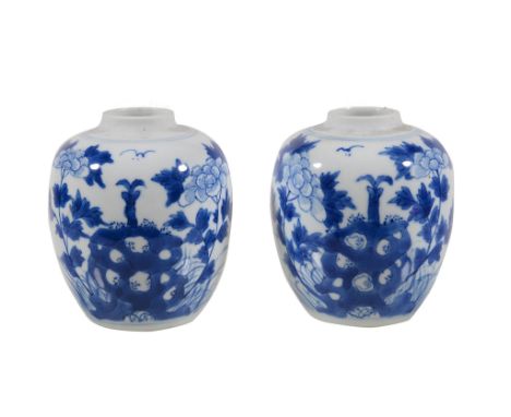 A small pair of Chinese blue and white ginger jars, painted in Kangxi style with flowers and rocks, 9.2cm high (2) 