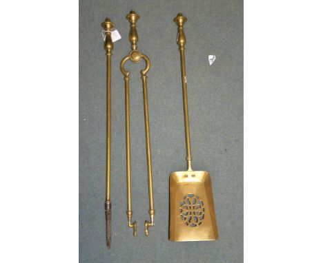 A set of three Victorian brass fire tools, 19th century, comprising shovel, poker and tongs, 69cm long; two brass columnar ta