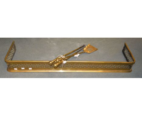 A pierced brass fire fender, early 19th century, 120cm wide; and three brass fire tools, 19th century 