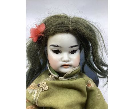 Schoennau and Hoffmeister  bisque head character15” Asian face doll in green embroidered gown .unusual character face with wi
