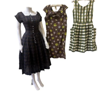 A 1940s striped shirtwaist dress with pockets, a deadstock 1950s plaid dress and integral net petticoat, complete with origin