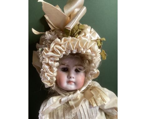  German and Barr and proschild 14”bisque head doll child doll cream attire tall bonnet and all original wooden body and limbs