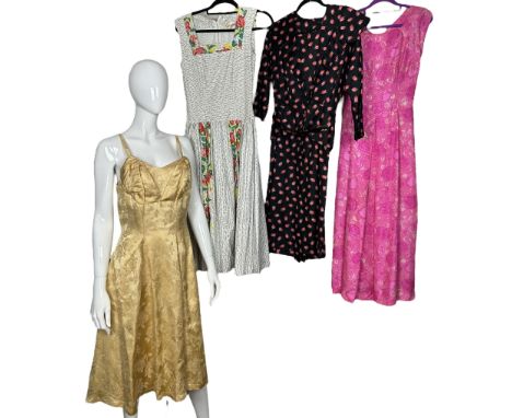 A 1940s dress in a black rayon damask, the sleeves and bow collar being made from an abstract deco print silk in black and wh
