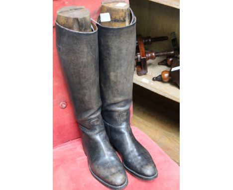 A pair of vintage leather riding boots with wooden trees 