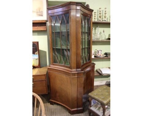 A pair of reproduction mahogany finished concave fronted corner cupboards upper bar glazed door having green painted Scheldt 