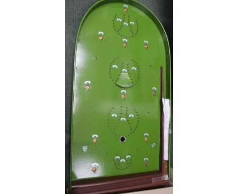 A box containing a vintage bagatelle board 