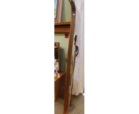 A vintage pair of Austrian wooden cross country skis, together with a pair of bamboo shafted poles 