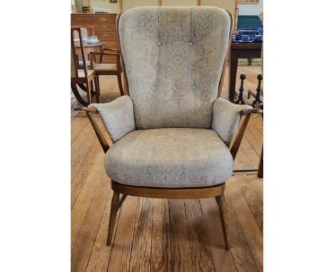 An Ercol 'Greensleeves' high back chair with a curved Windsor back. 