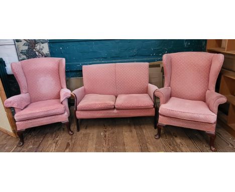 A pink Parker Knoll upholstered sofa (87cm x 120cm x 64cm) and a pair of wingback chairs (96cm x 74cm x 84cm). Reupholstered 