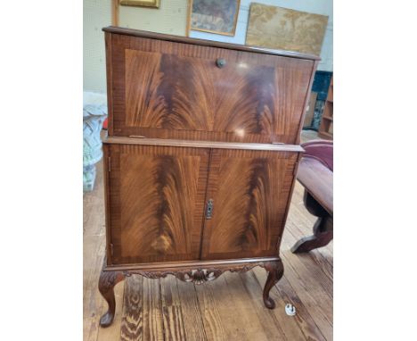 A mahogany cocktail/ drinks cabinet with drop down front,original mirrored and inlaid glass back and interior, and two door c