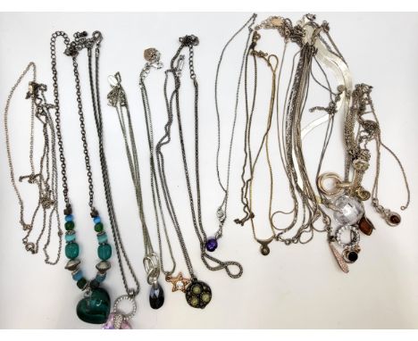 A silver 'pearl' pendant and chain, an amber pendant set in silver on a silver chain, an oval amber in silver pendant on a si