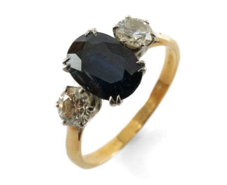 18CT GOLD SAPPHIRE & DIAMOND THREE STONE RING, the central oval cut sapphire measuring 2.1cts approx., flanked by two round b