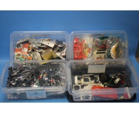 FOUR SMALL STORAGE BOXES WITH CONTENTS, including model parts, wheels, tyres, figures etc. 