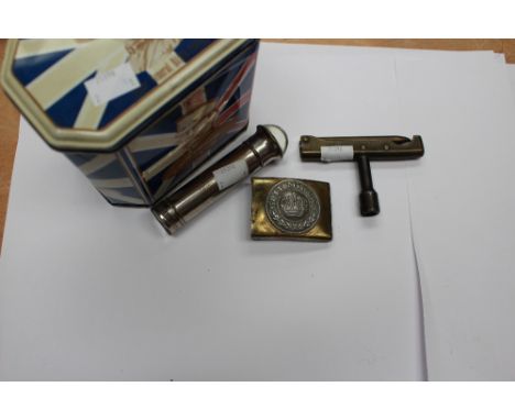 A World War One German belt buckle, 1930's flashlight, Baden Powell tin, hole punch