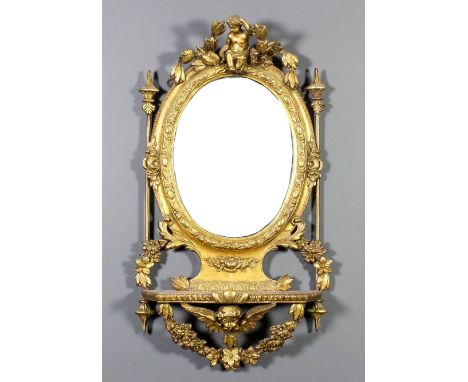 A 19th Century French gilt framed oval wall mirror with bead and scroll moulded frame, inset with bevelled mirror panel surmo