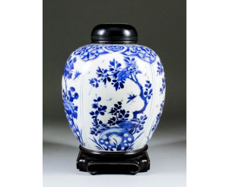 A Chinese blue and white porcelain ovoid ginger jar painted with four shaped panels of flowering branches and insects, and wi