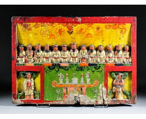 A Chinese carved and painted hardwood boat people junk altar, carved with thirteen seated figures above a central altar inscr