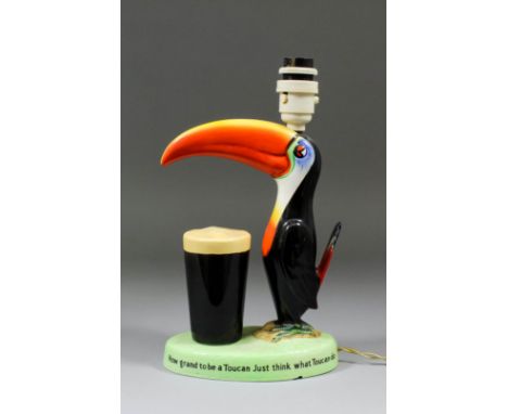 A Carlton Ware "Guinness" pottery toucan pattern electric table lamp, 9.25ins high, with shade for same, 17.5ins high overall