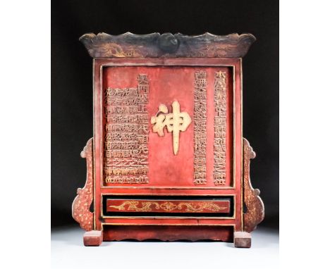 A large Chinese carved red painted and giltwood altar table screen, the shaped top carved in low relief with dragons and with